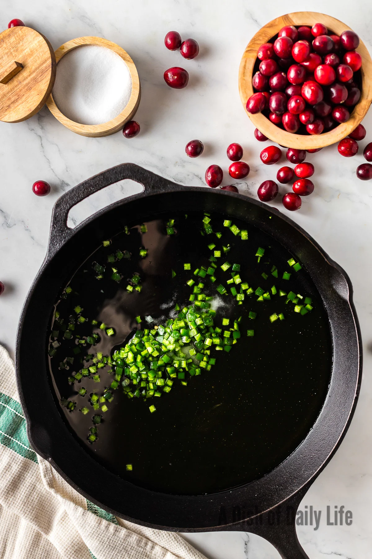 Jalapenos, honey, salt and water added to a skillet, uncooked.