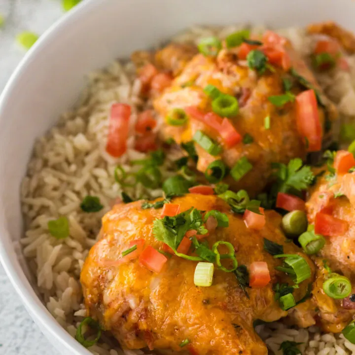 3 chicken thighs in a bowl of rice