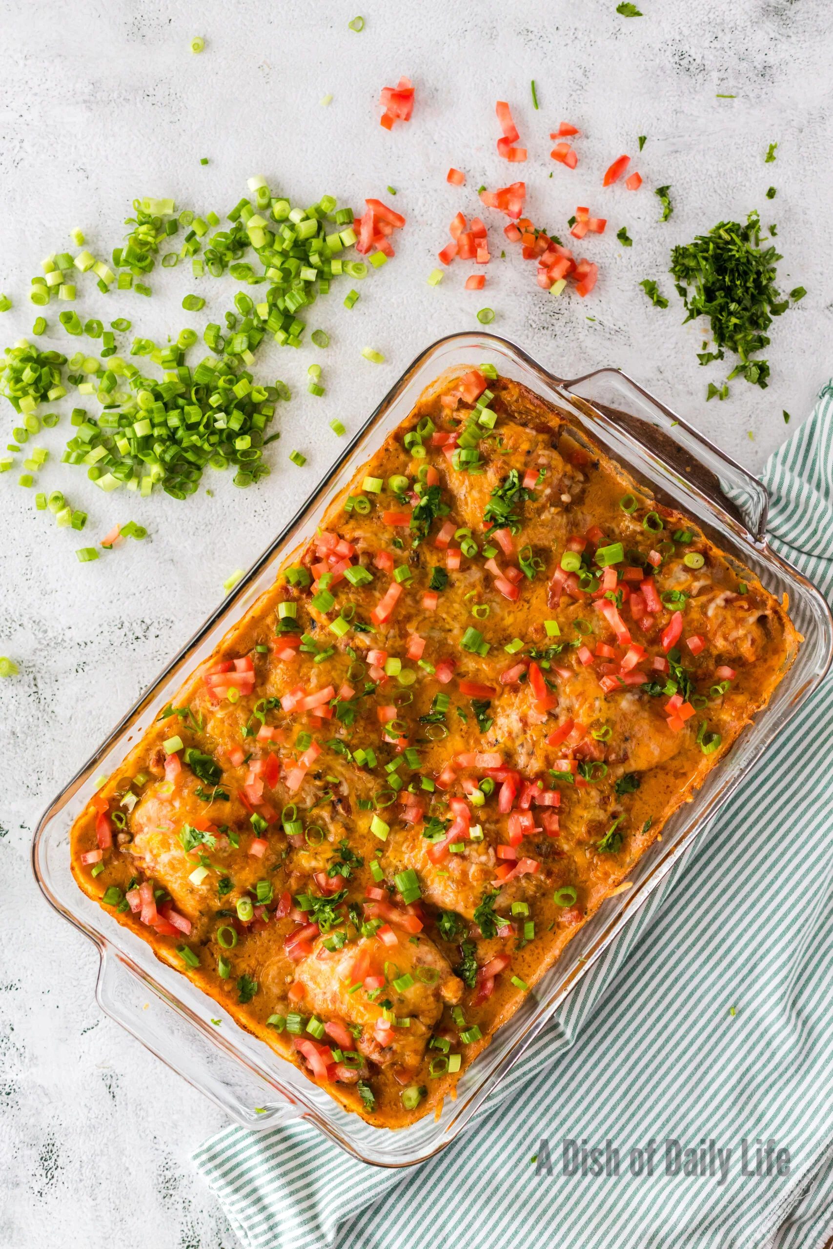 Baked Chicken thighs topped with tomatoes, green onions and cilantro.