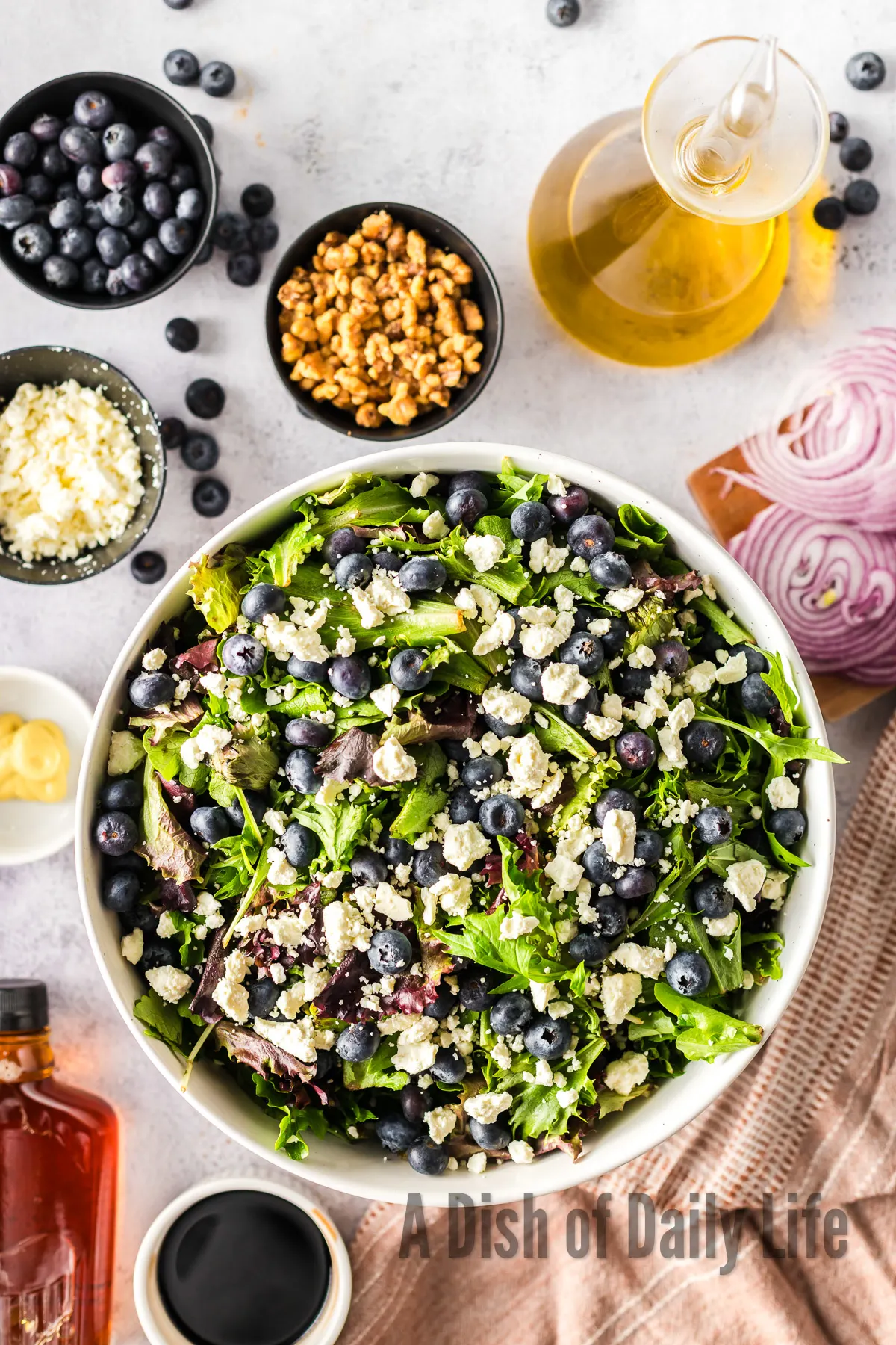 Feta cheese crumbled over lettuce and blueberries