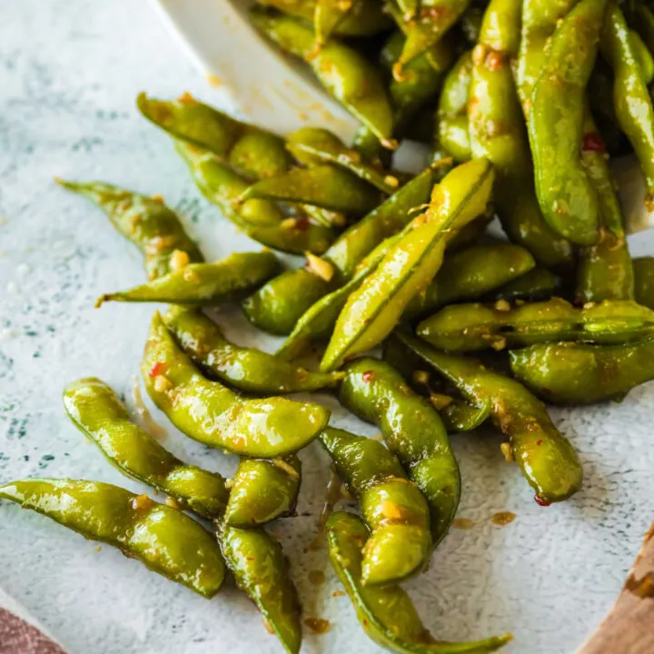 bowl full of chili edamame tipped over