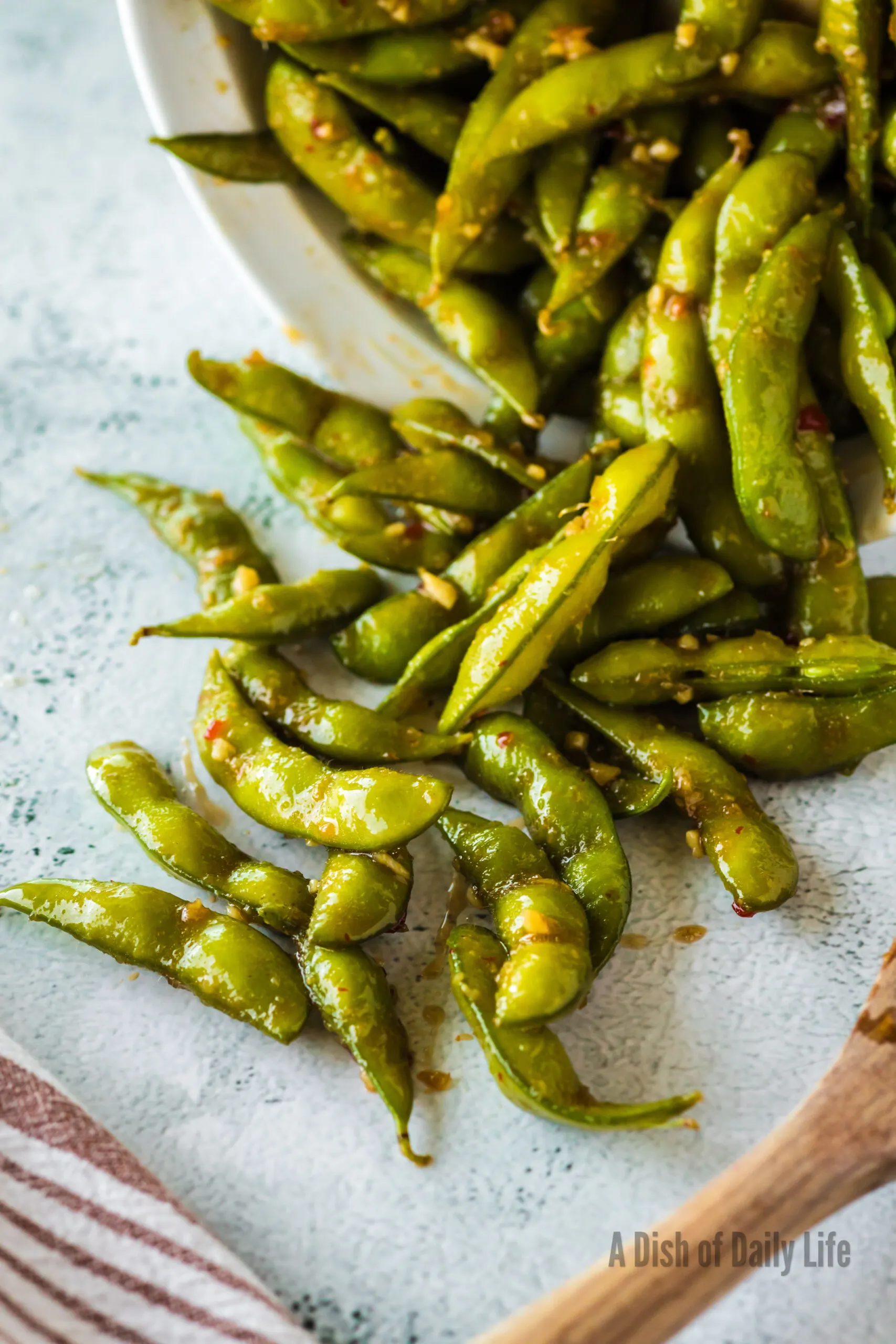 bowl full of chili edamame tipped over