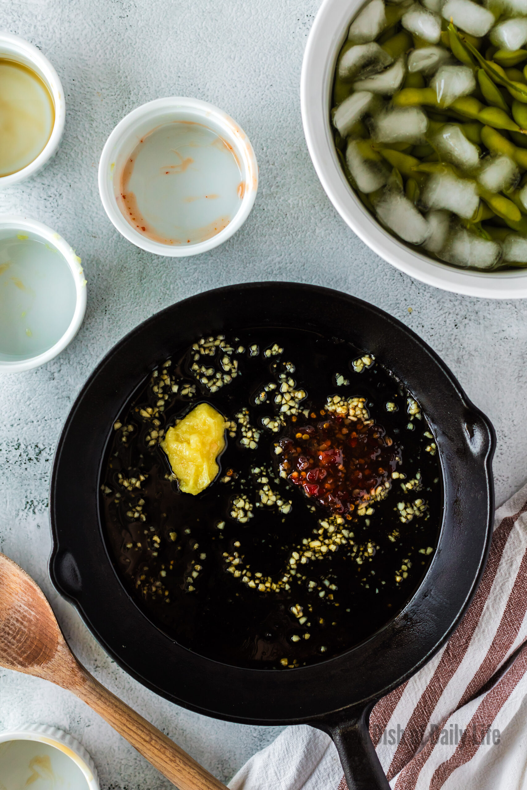 ginger paste, sweet chili sauce, soy sauce and maple syrup added to garlic