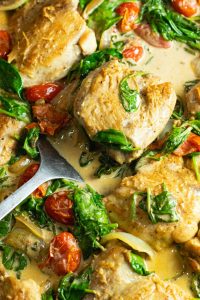Mustard Cream Chicken with Spinach and Tomatoes being served
