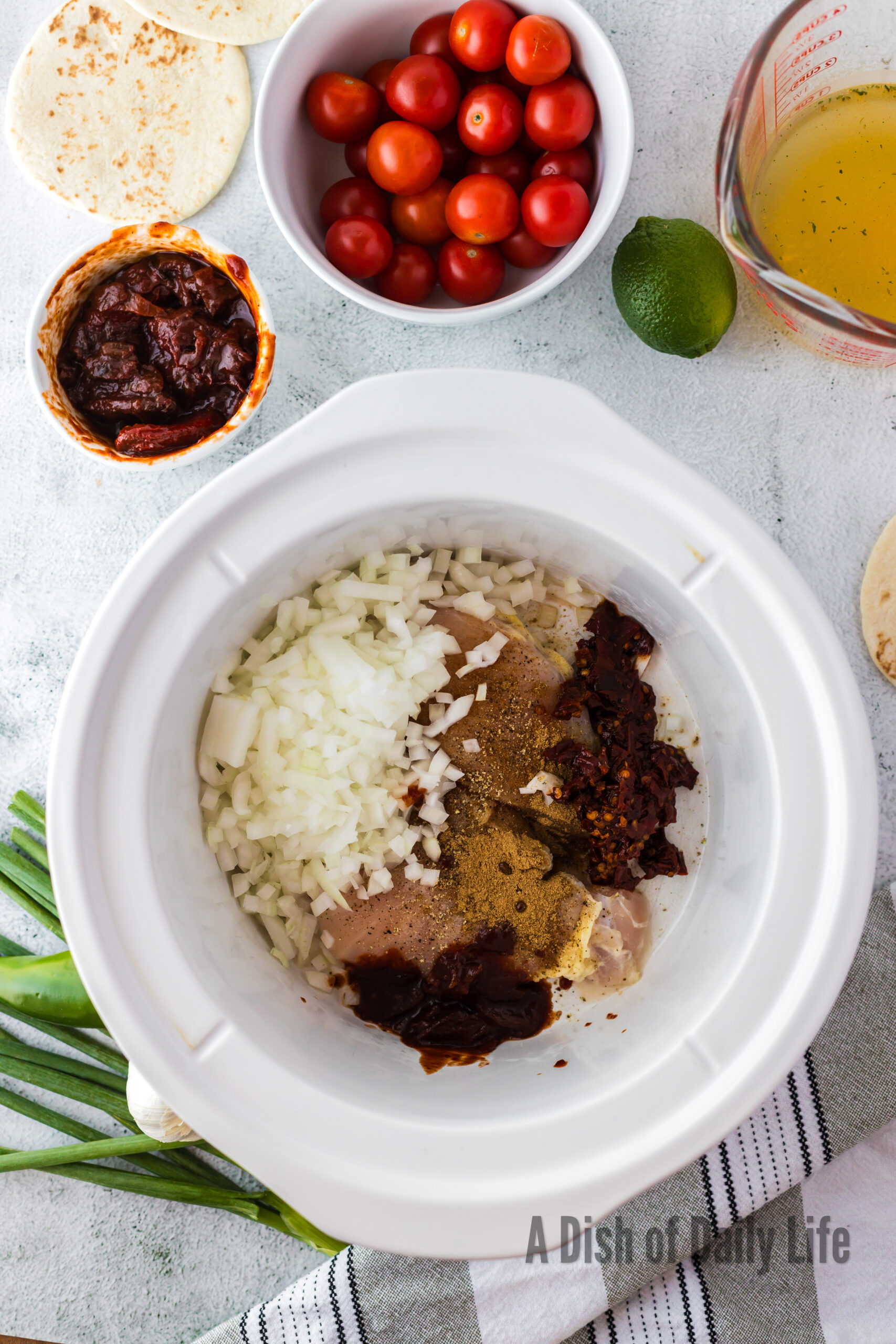 Onions, chiles, and adobo sauce all added to crock pot