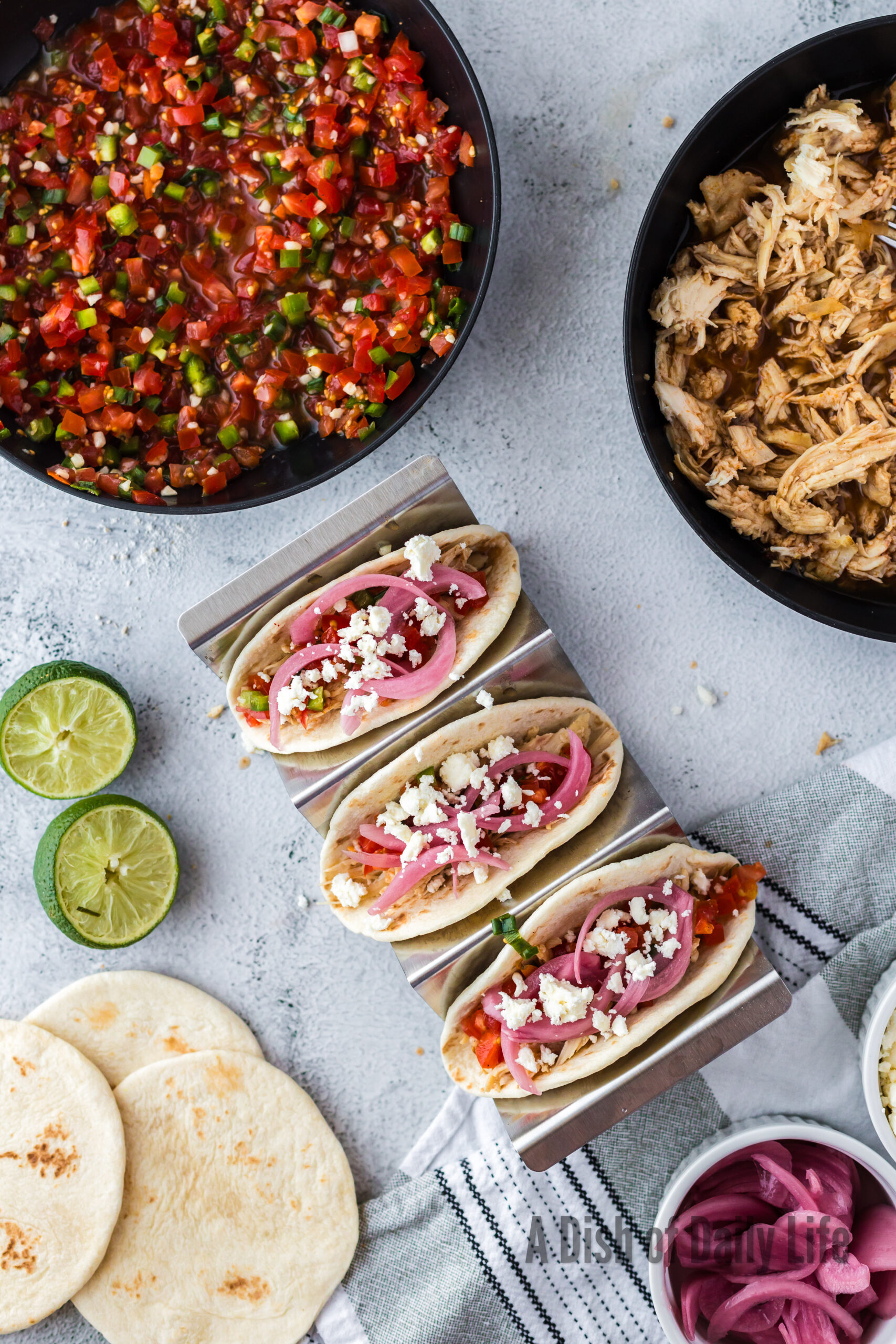 3 tacos with shredded chicken, salsa, pickled red onions and cheese