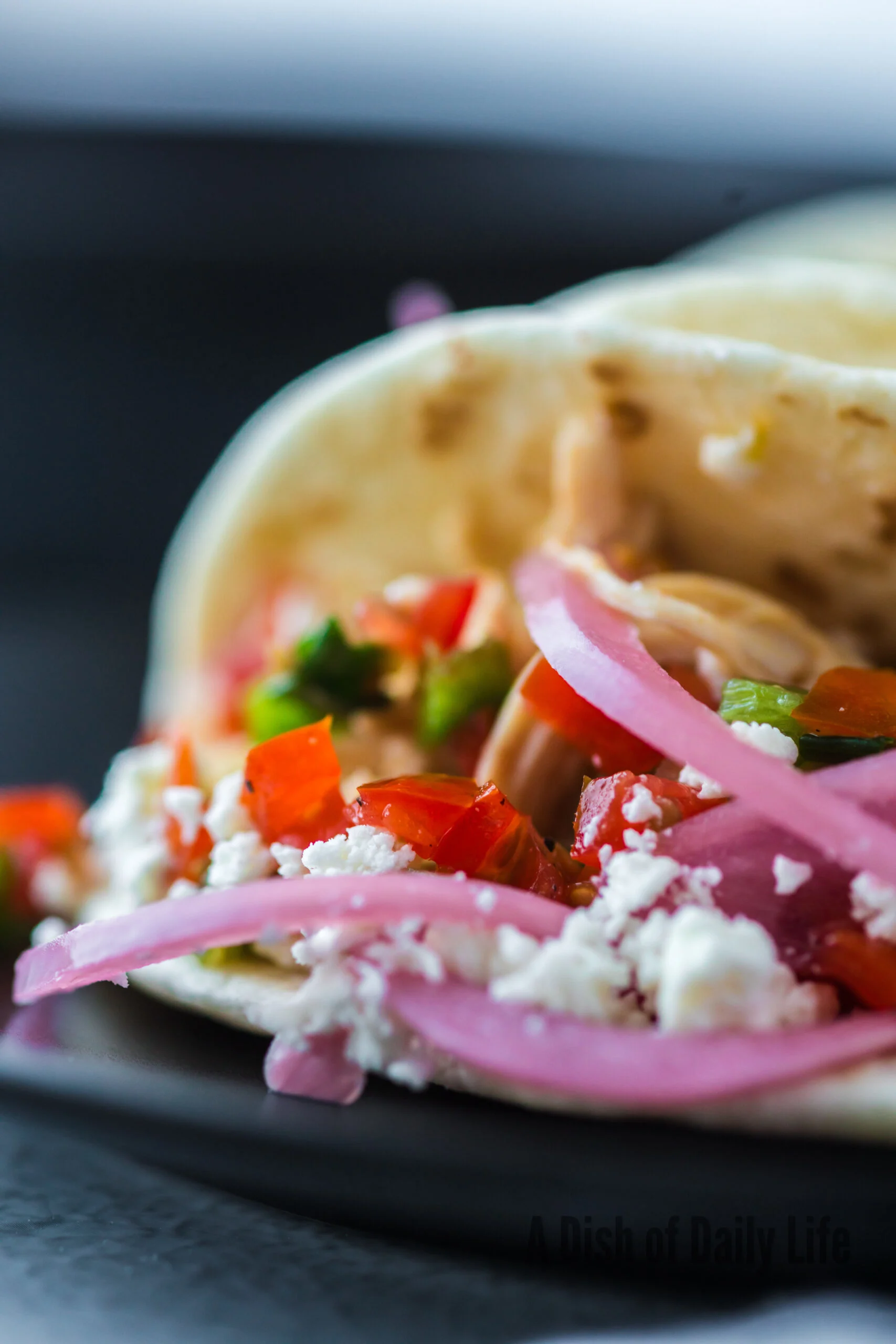 zoomed in image of taco on a plate on it's side showing filling