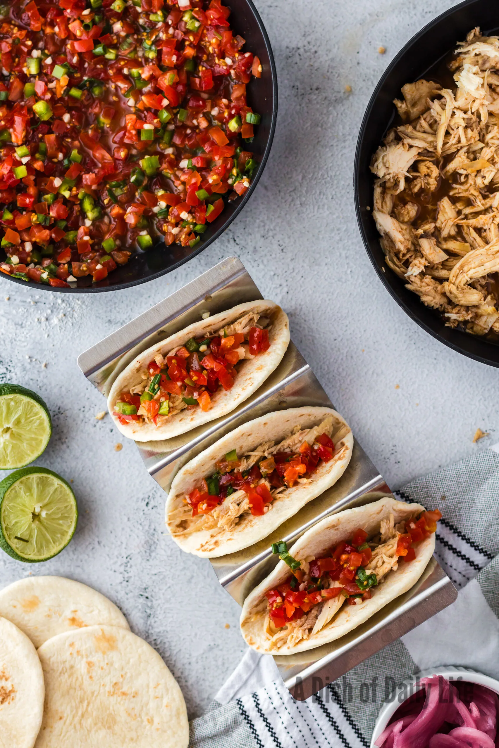 3 tacos with shredded chicken and salsa