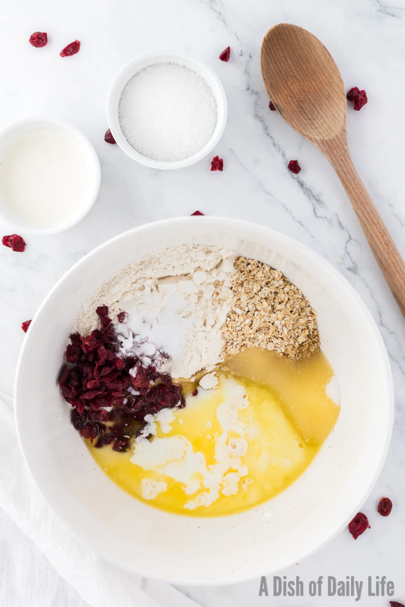 flour, oatmeal, sugar, baking powder, baking soda, salt, butter and buttermilk in a bowl, unmixed