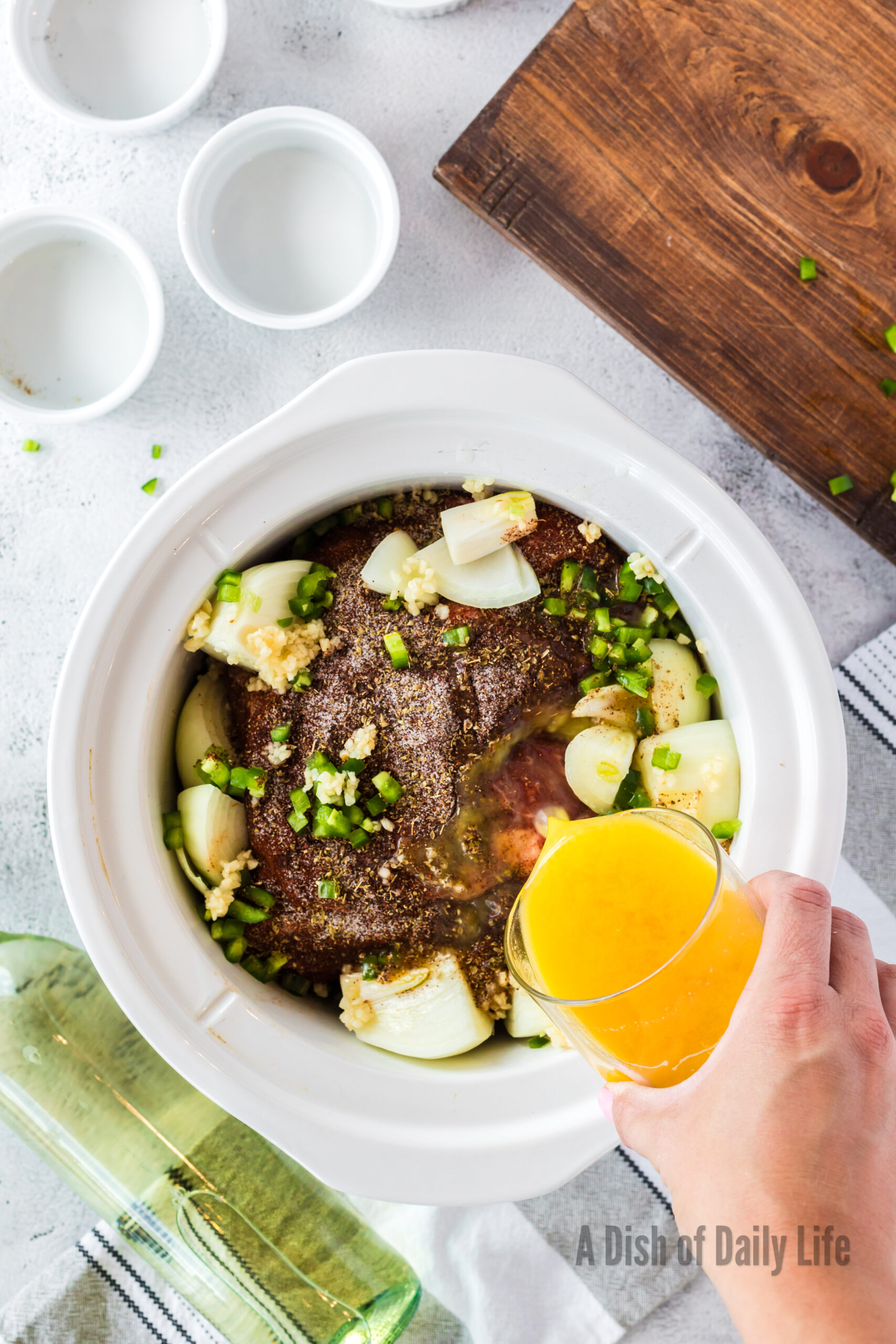 butter, garlic and liquids added to pork butt in crock pot