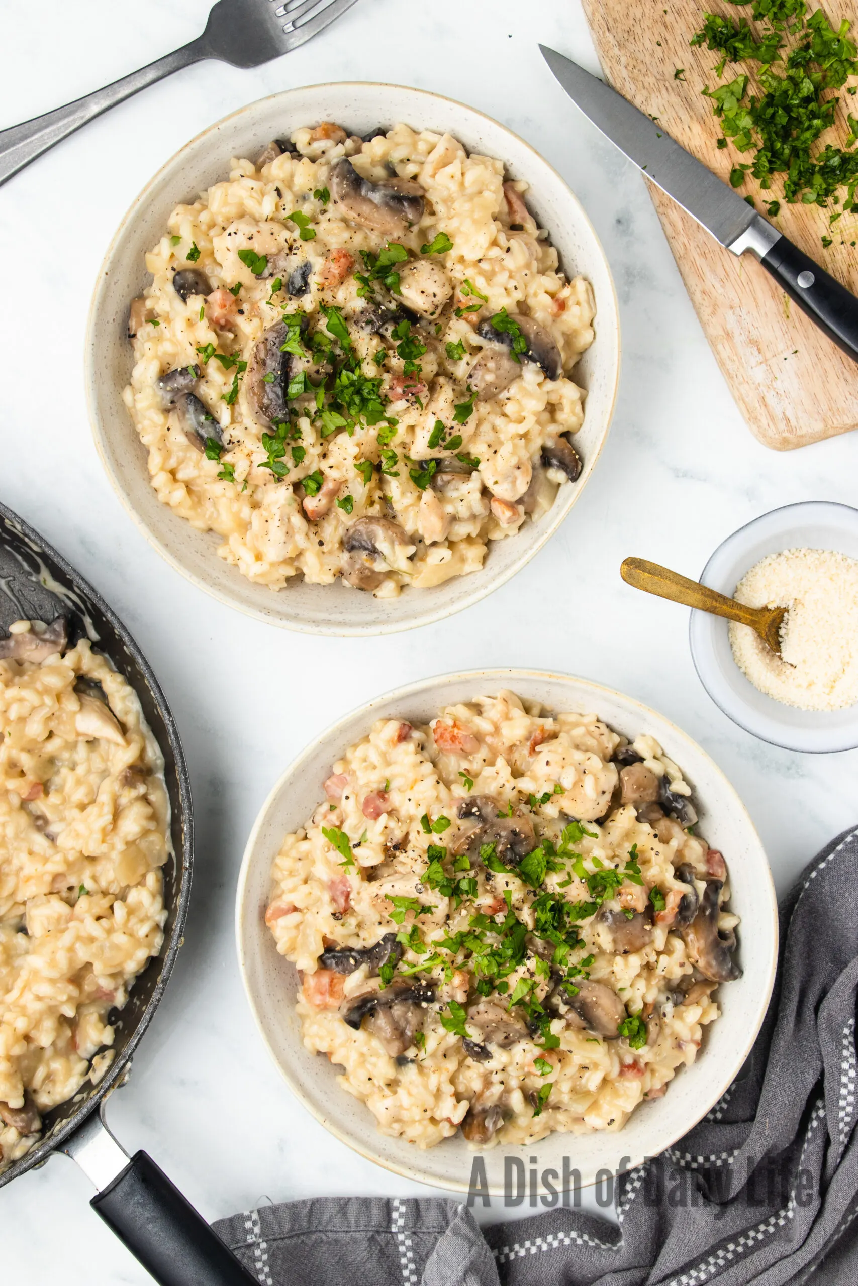 zoomed out image of risotto in pan with two bowls of chicken and mushroom risotto next to it