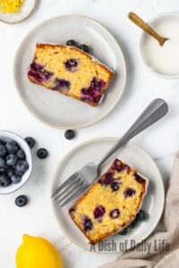 two slices of cake on a plate to show off yummy blueberries and moist cake