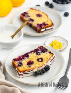 side view of two slices of blueberry cake on plates
