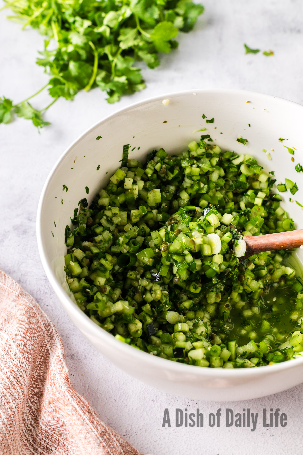 wooden spoon stirring pico in bowl