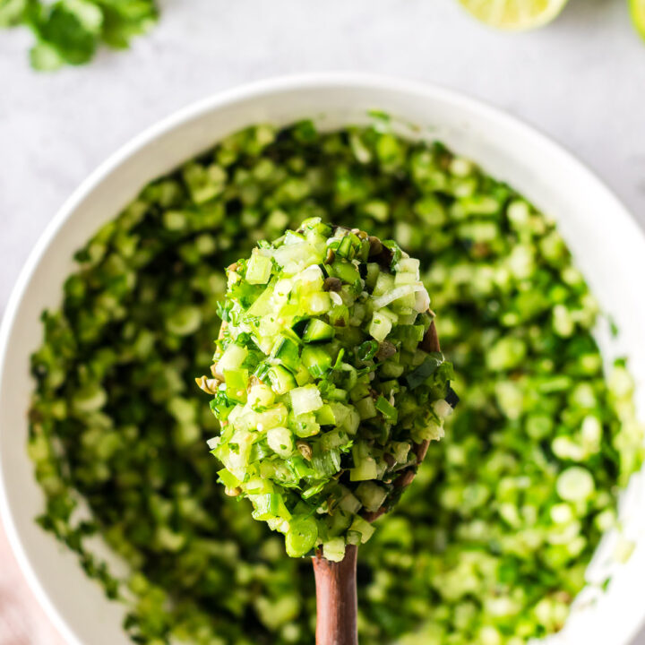 wooden spoon scooping out a large portion of pico from bowl