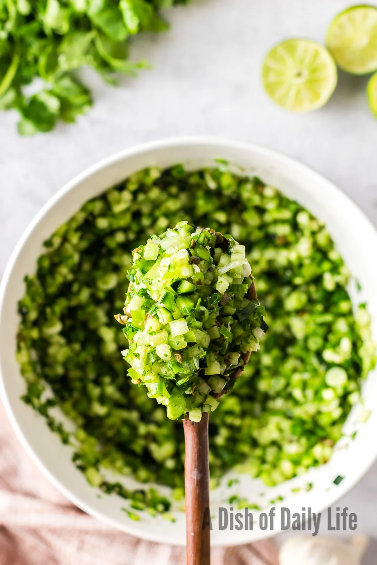 wooden spoon scooping out a large portion of pico from bowl