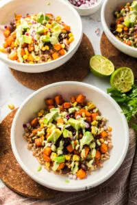 top view of two farro bowls with sweet potatoes, ready to enjoy