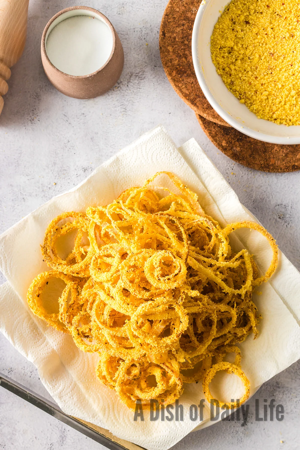 zoomed out image of fried onion rings on paper towels