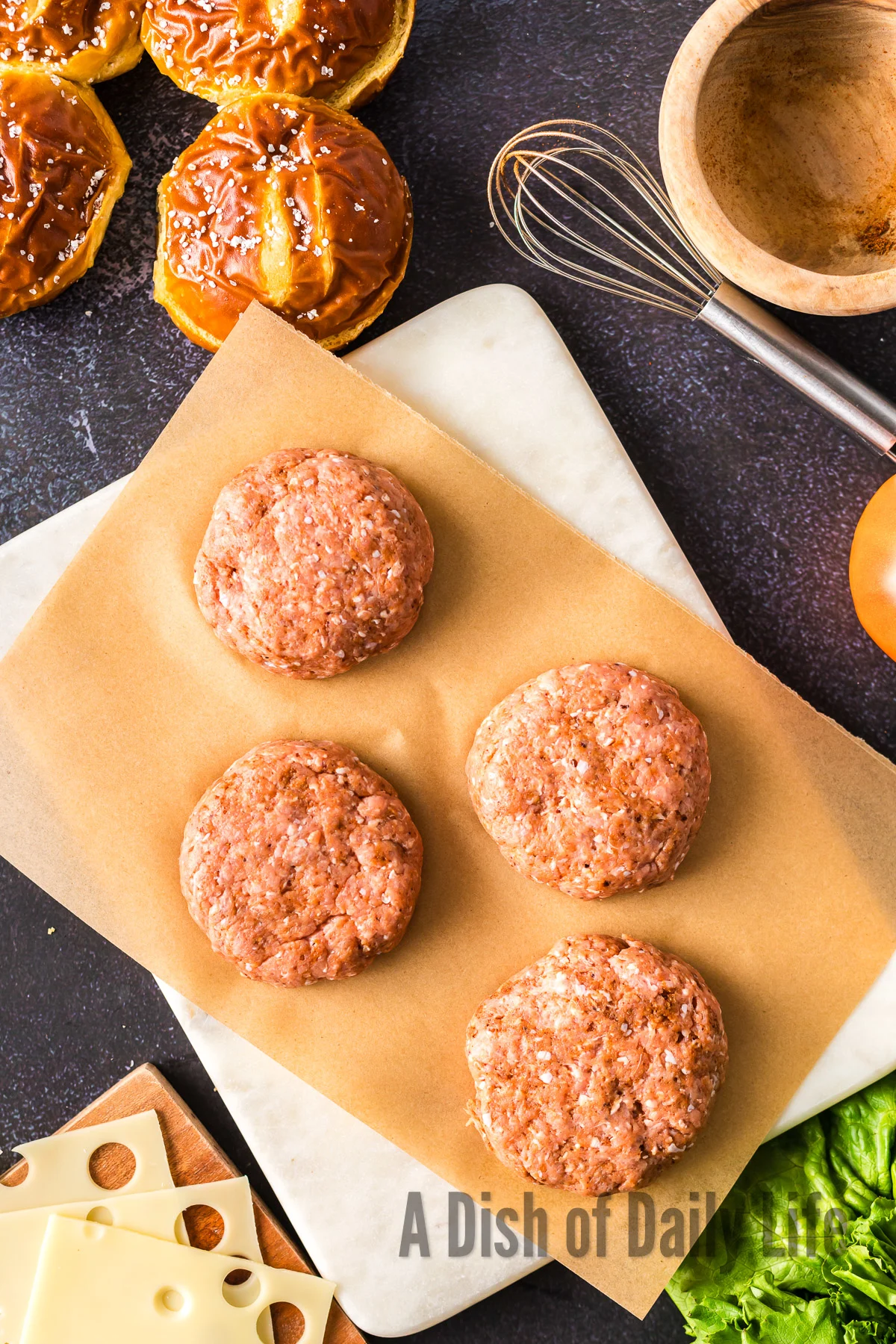 4 ground beef patties sitting on parchment paper