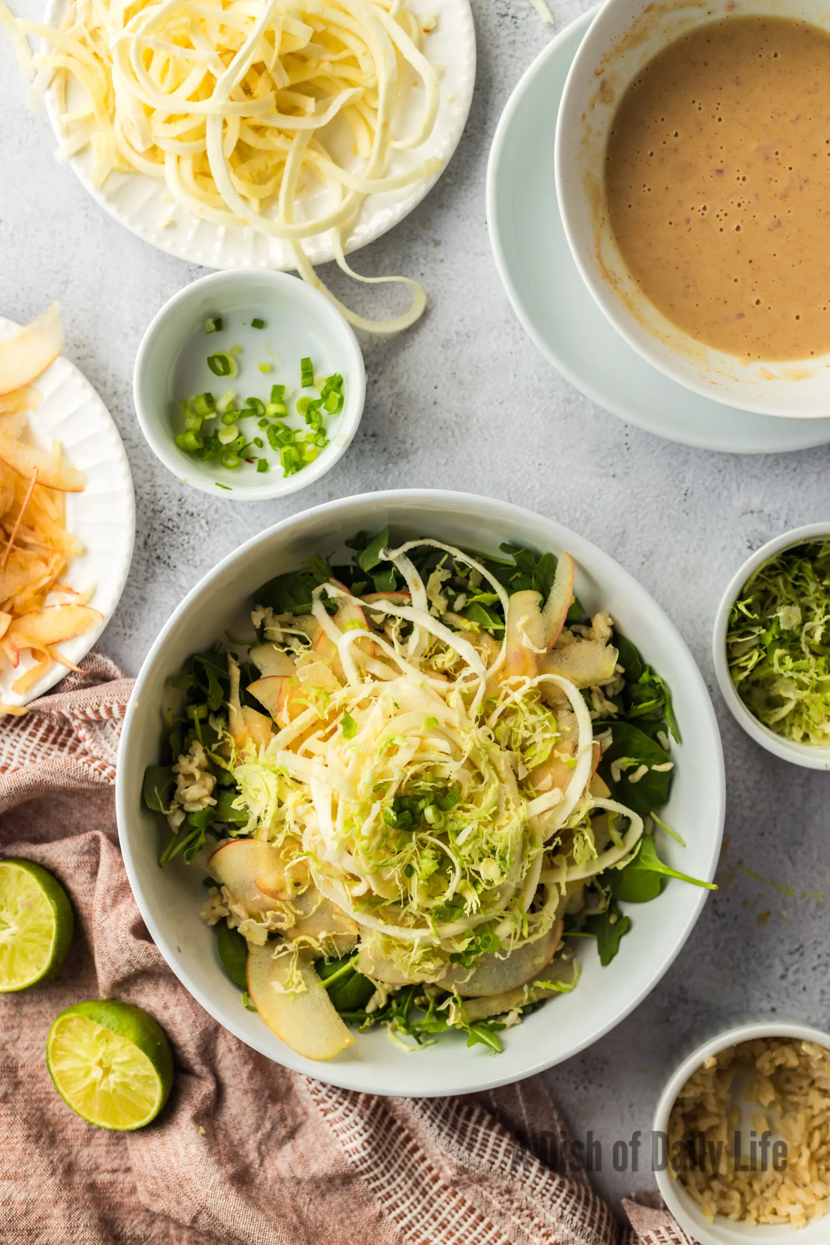 All ingredients for Apple Parsnip Salad layered in a bowl