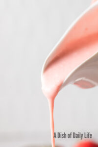 zoomed in image of salad dressing being poured