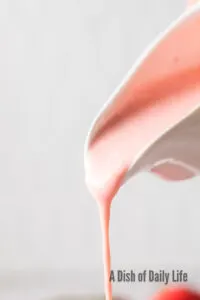 zoomed in image of salad dressing being poured