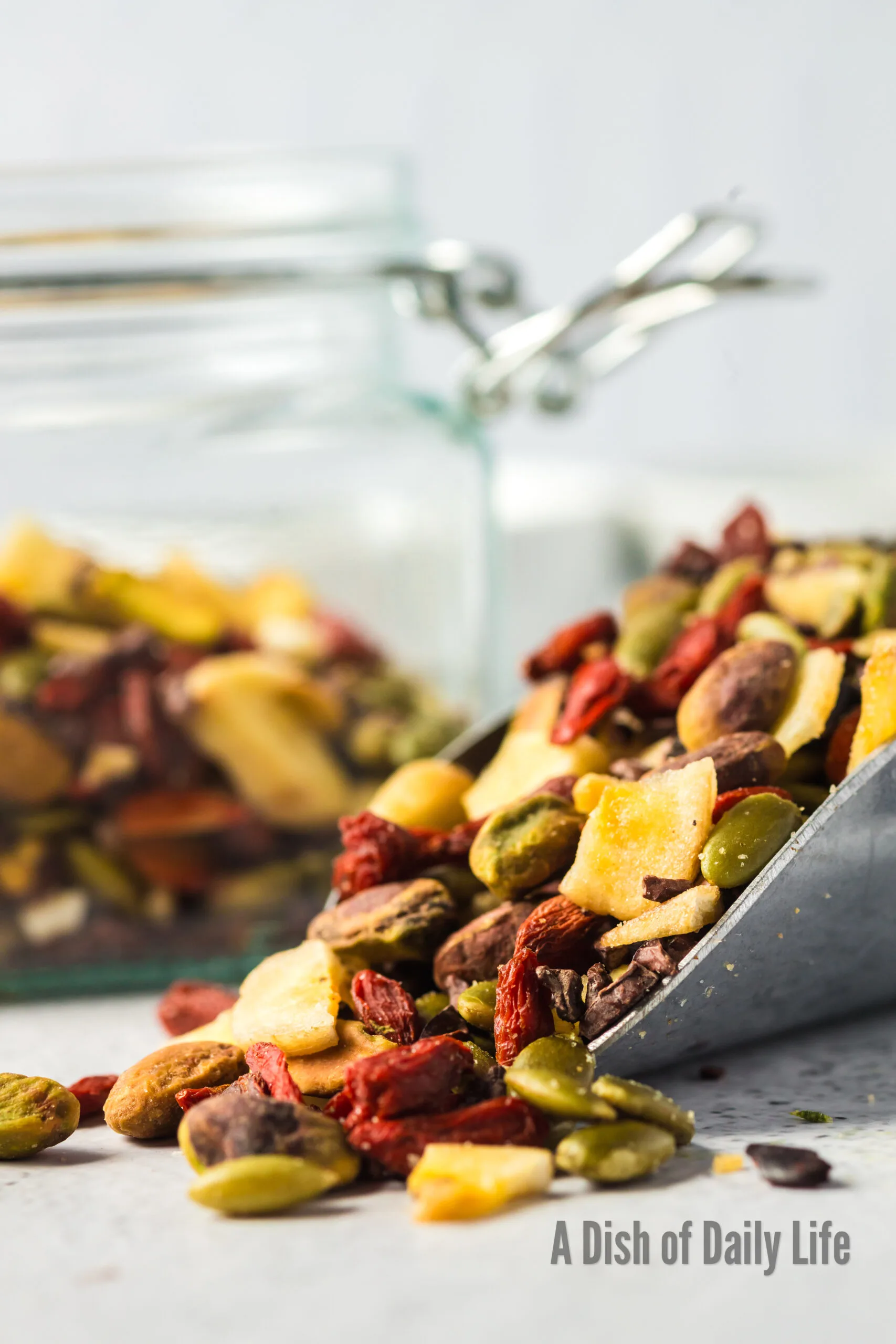 zoomed in image of a scoop of healthy trail mix on the counter