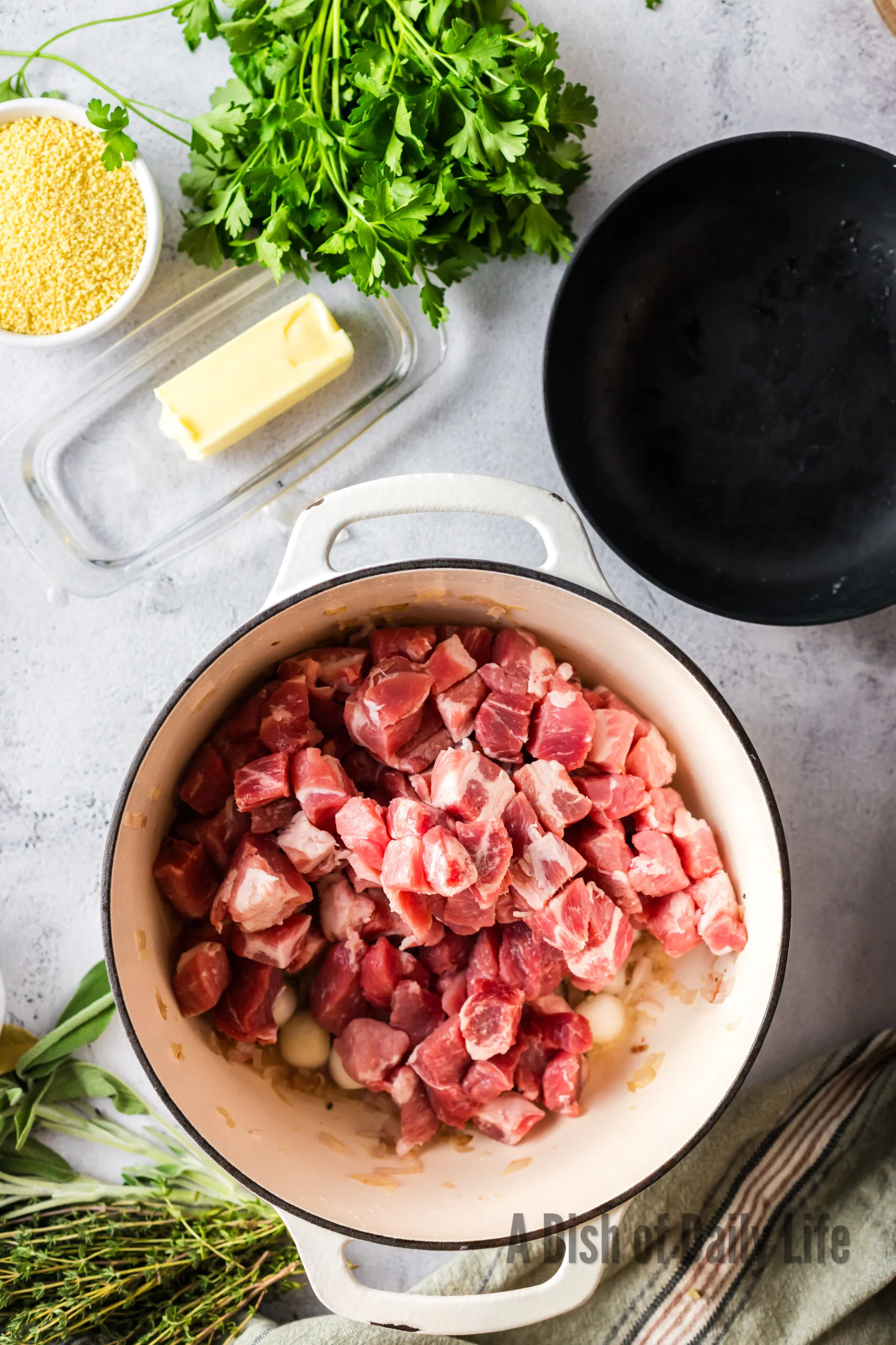 Pork added to dutch oven with salt and pepper