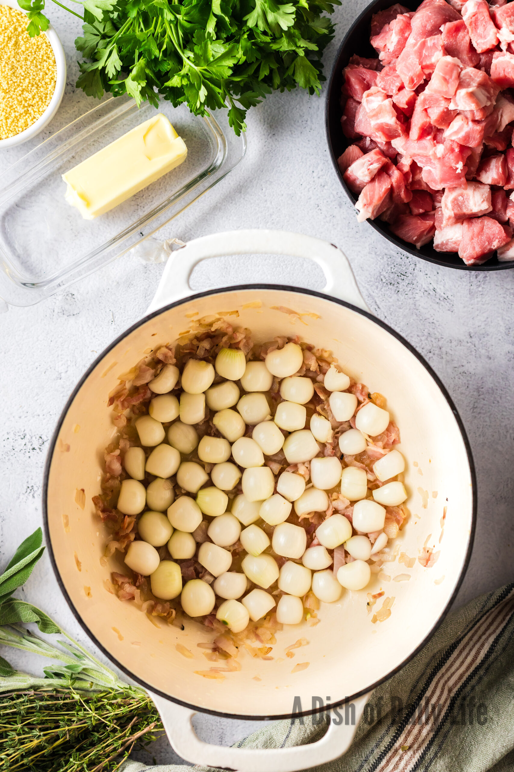 Pearl onions added to dutch oven