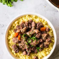 Braised Pork Shoulder on top of a bed of couscous.