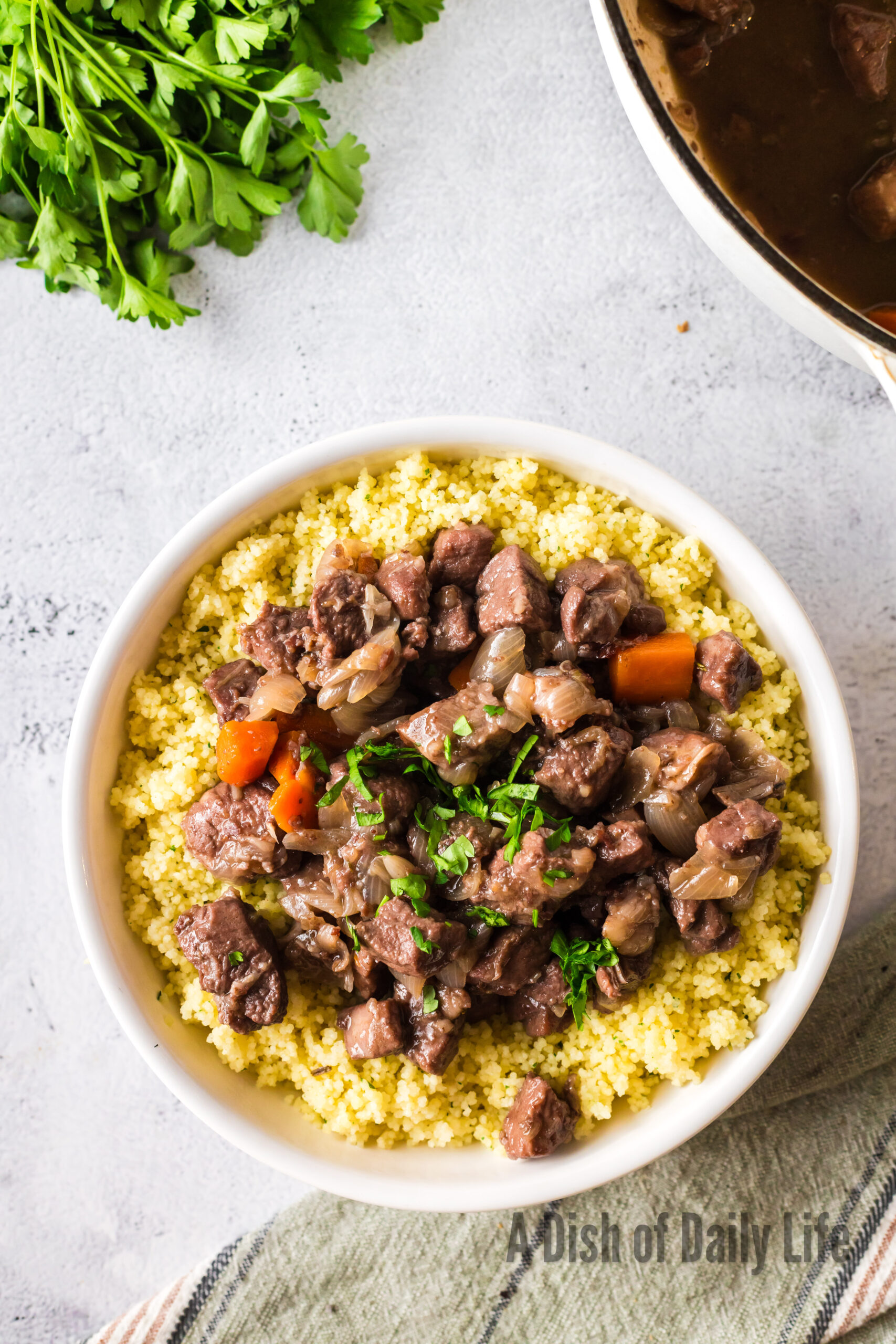 Braised Pork Shoulder on top of a bed of couscous.