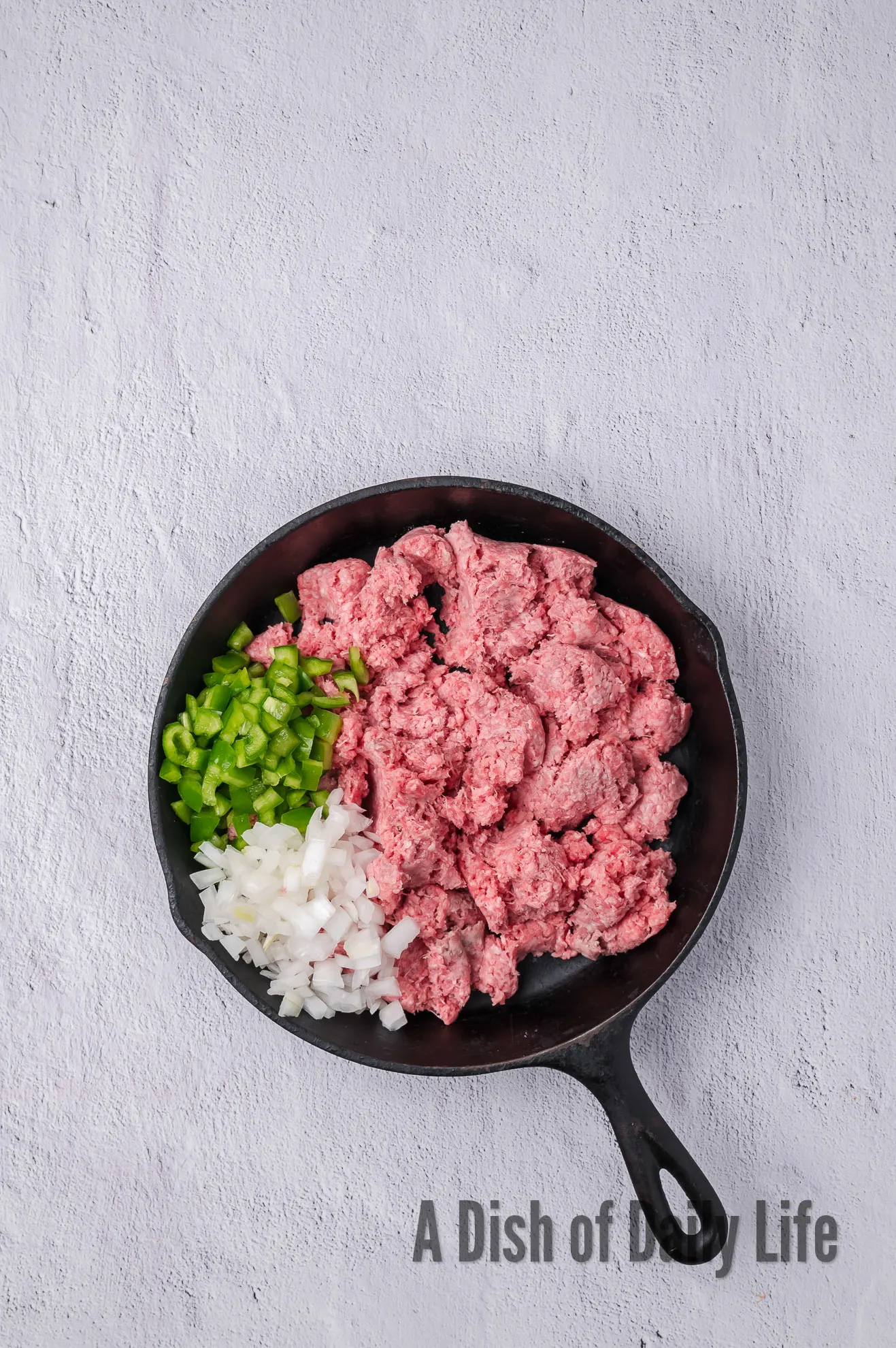 ground beef, onion, and bell pepper in a skillet.