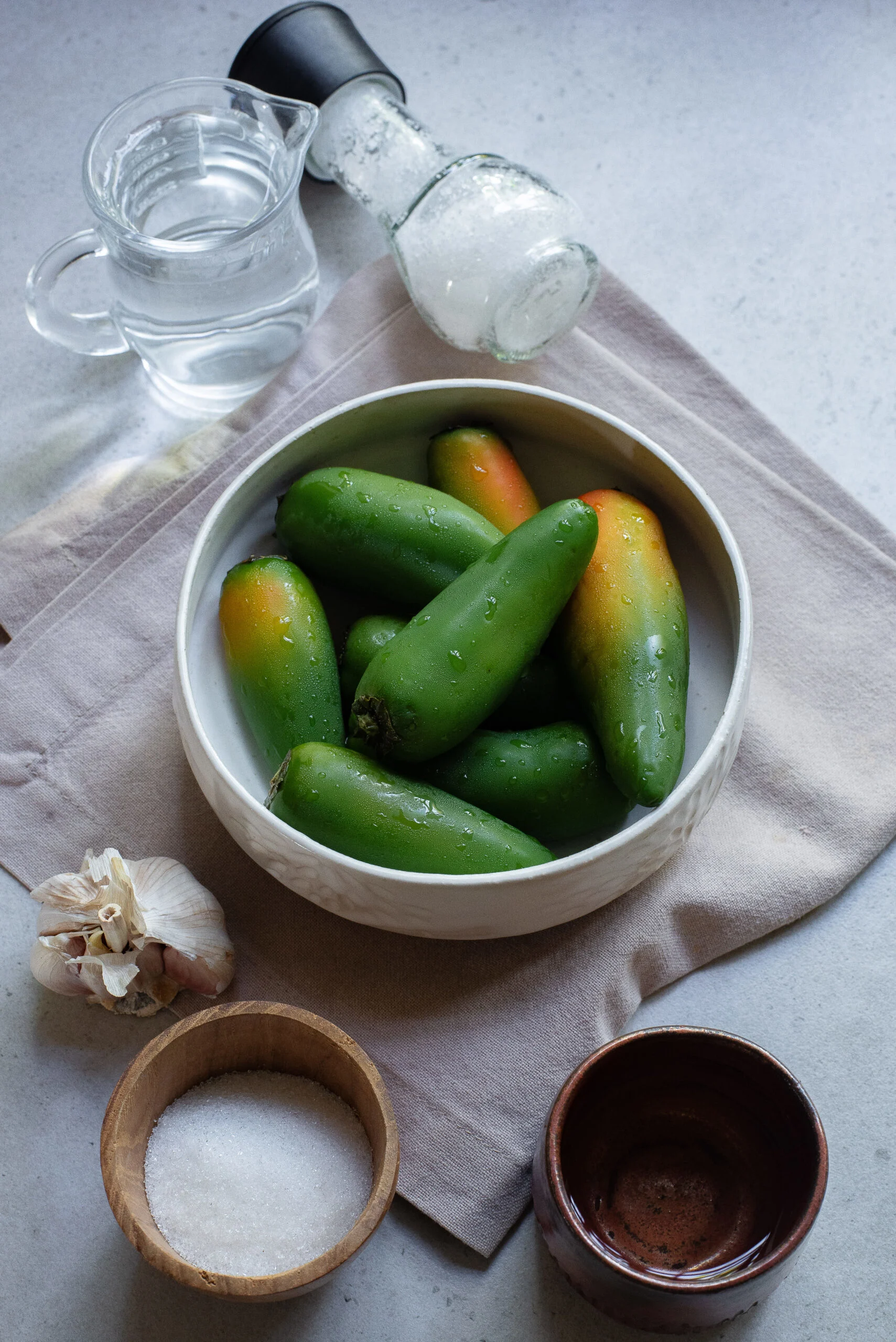 All ingredients laid out on the counter, ready to assemble refrigerator jalapenos.