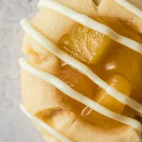 zoomed in image of a cookie with a white chocolate drizzle.