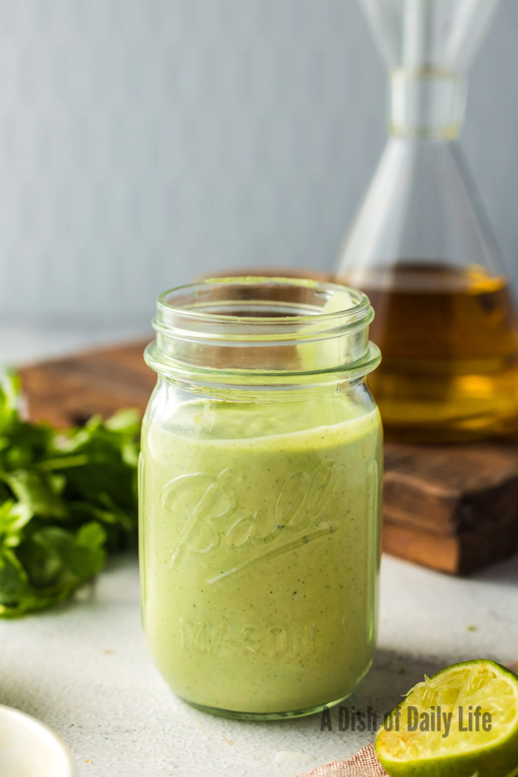 side view of jar full of cilantro lime dressing.
