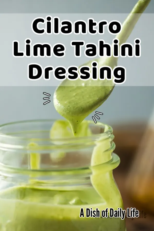 Main image for Cilantro Lime Tahini Dressing. Dressing is in a jar with a spoon scooping some out.