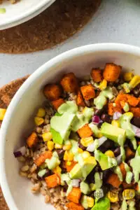 Tahini dressing poured over sweet potato salad