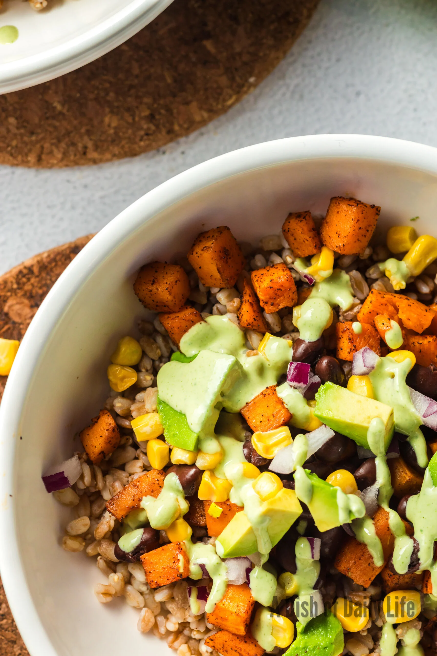 Tahini dressing poured over sweet potato salad