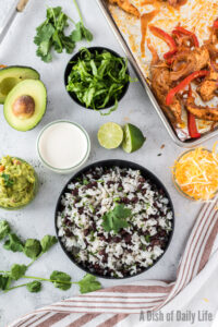 Fajita bowl is ready to build. Rice is on the bottom of the bowl .