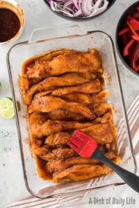 marinated chicken in a casserole dish.